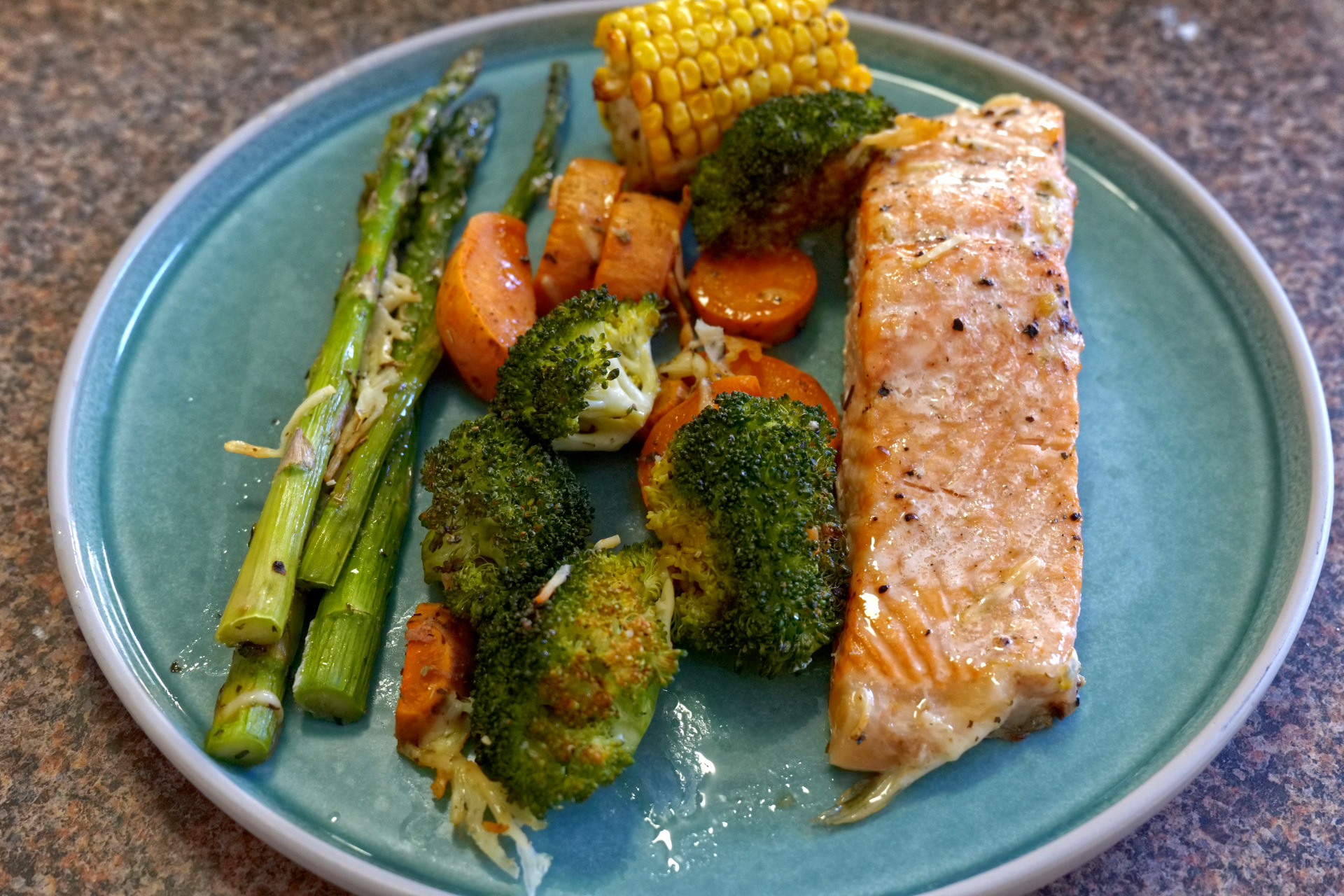 Healthy oven baked salmon and vegetables on a sheet pan