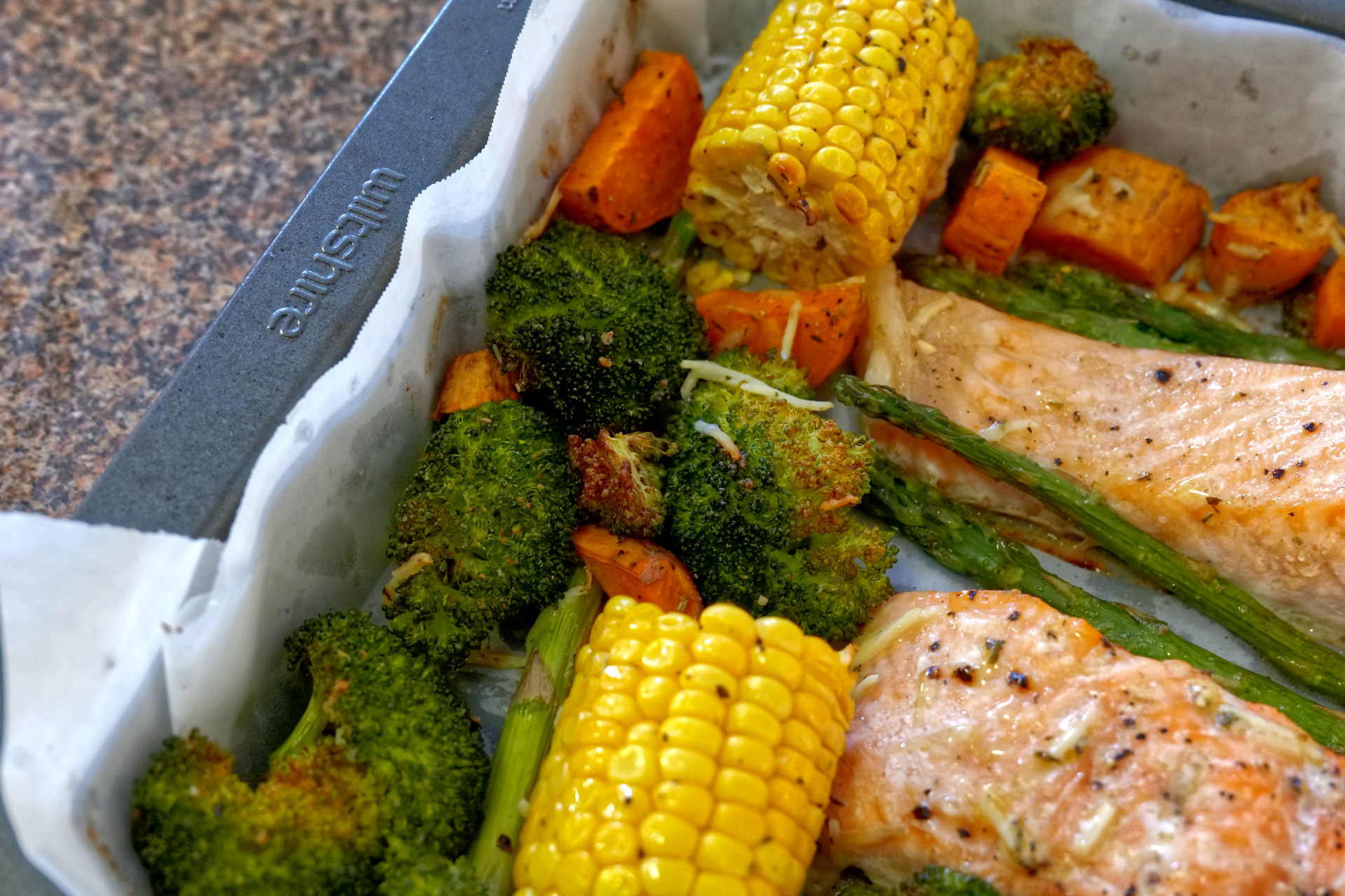 Healthy oven baked salmon and vegetables on a sheet pan