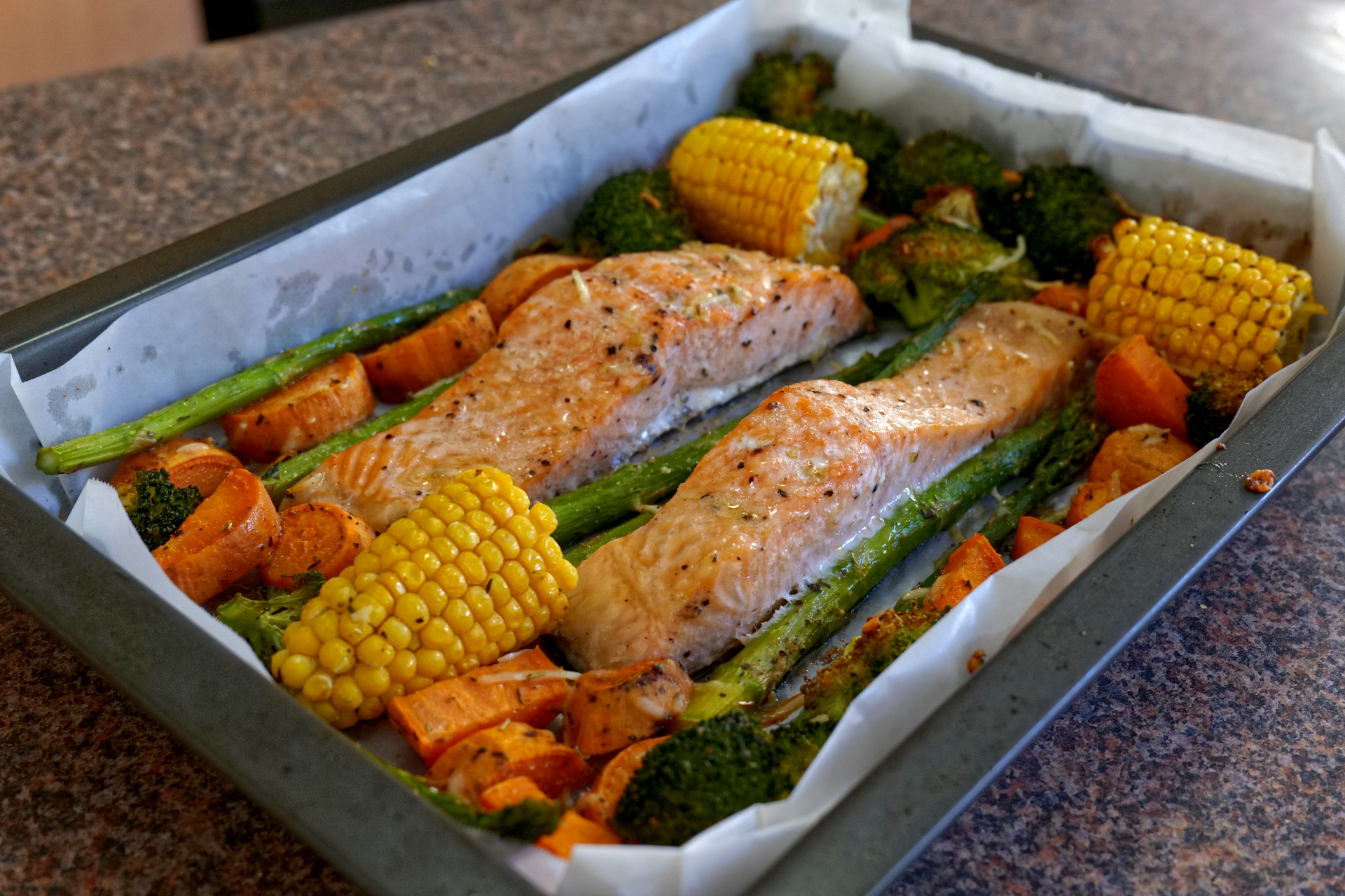 Healthy oven baked salmon and vegetables on a sheet pan