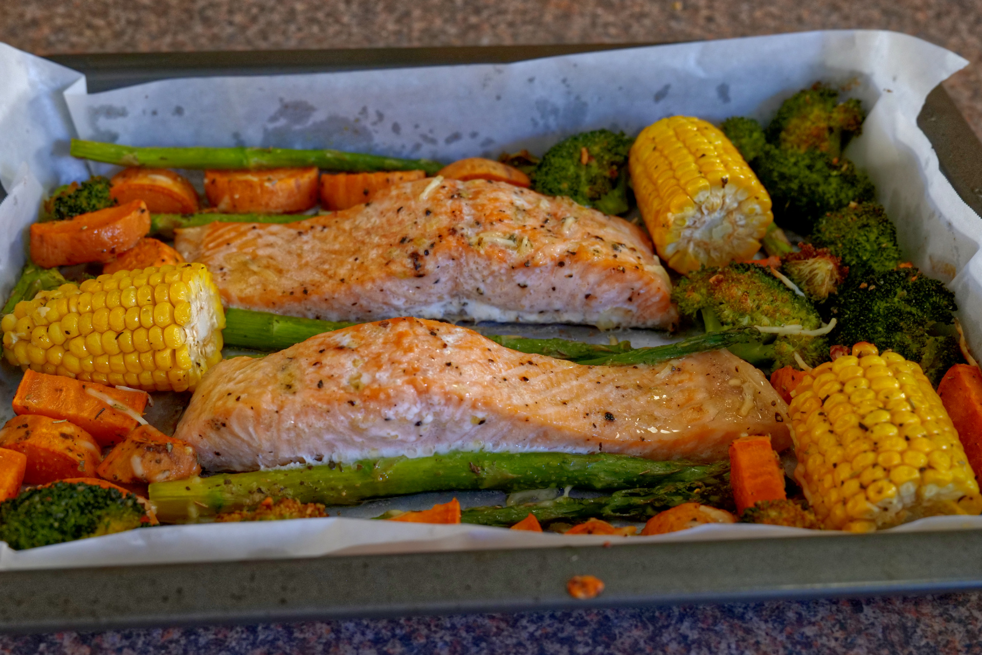 Healthy oven baked salmon and vegetables on a sheet pan
